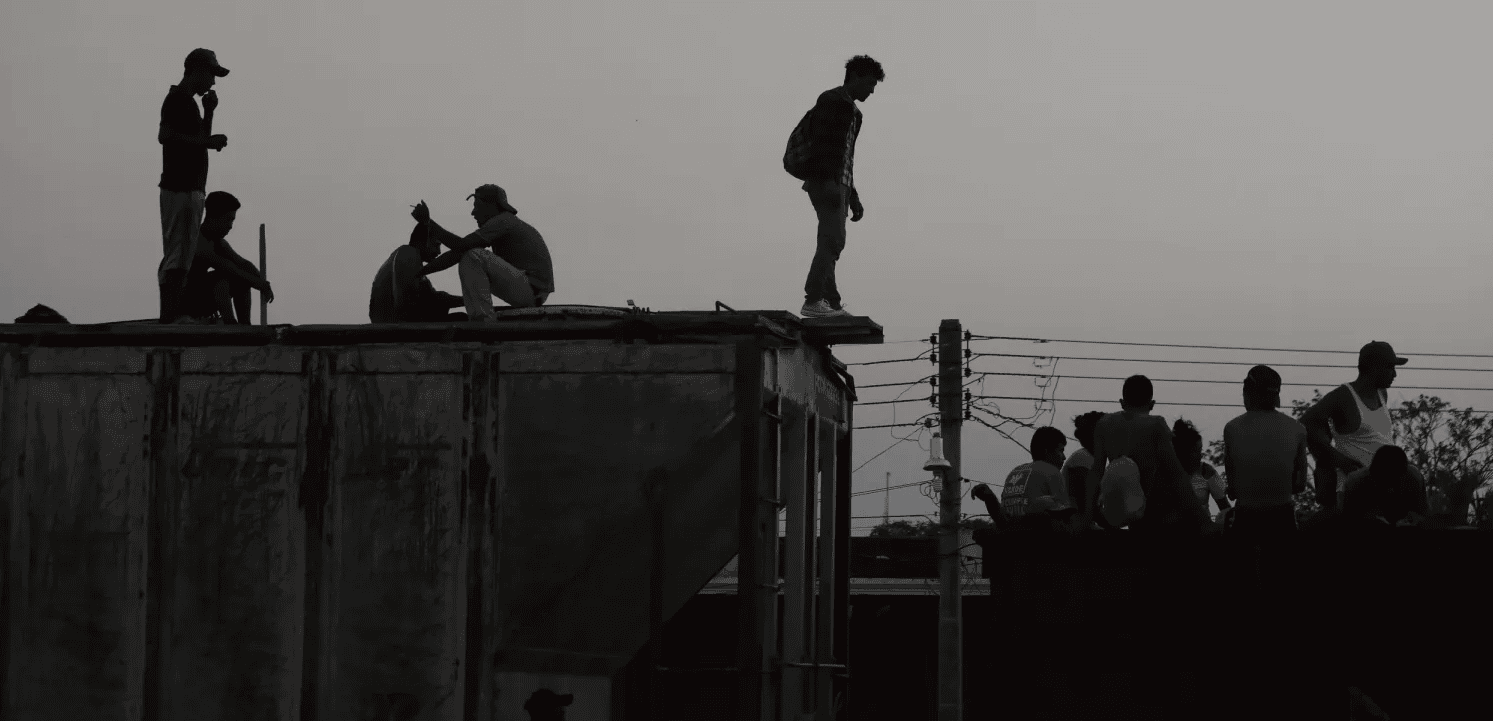 Deported family members on a rooftop seeking reunion, highlighting immigration struggles.