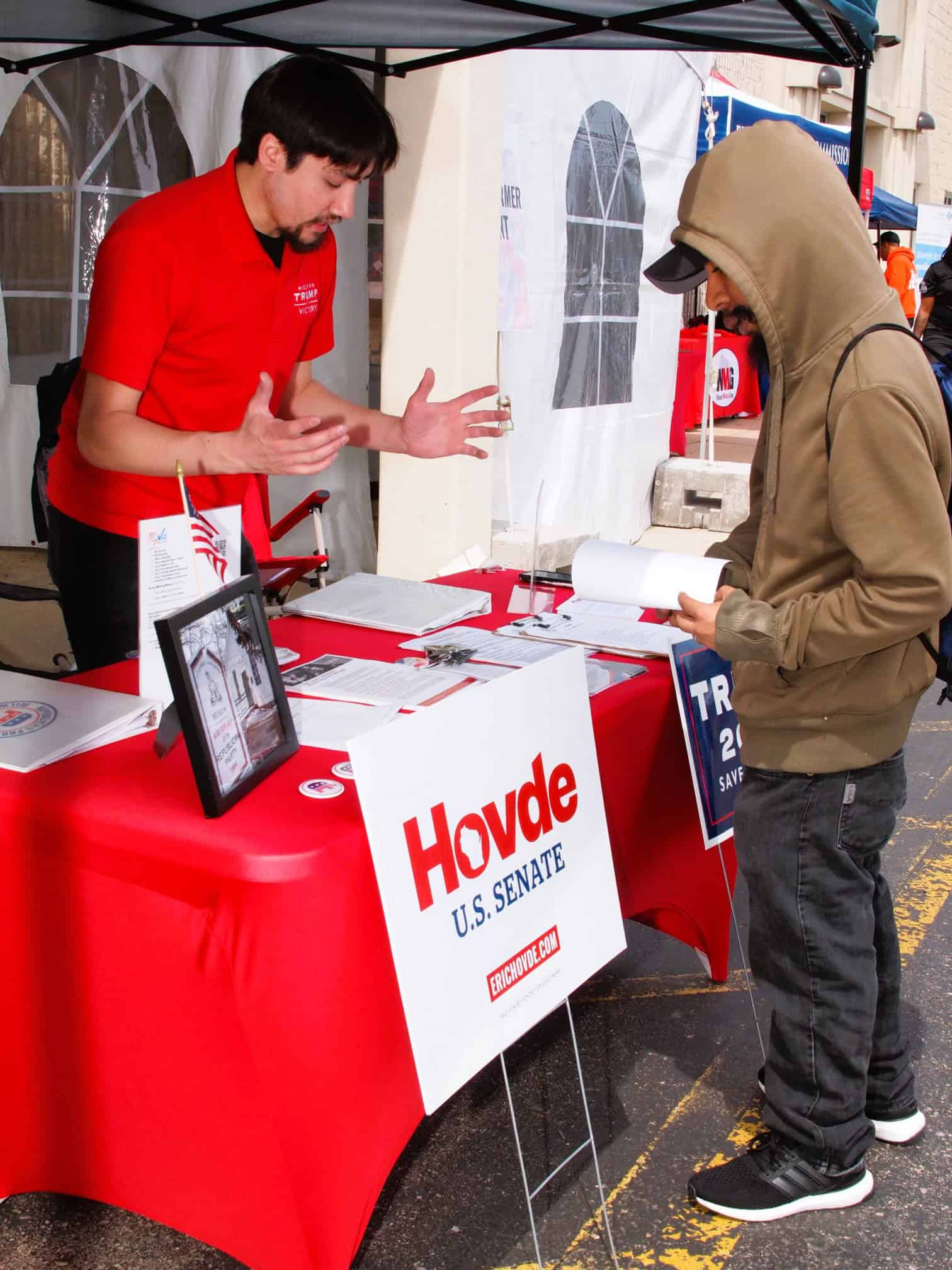 Voter engaging with campaign staff at Wisconsin Latino voter outreach event.