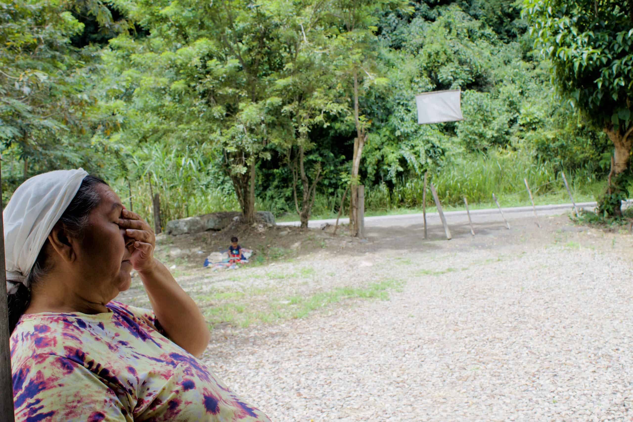 Venezuelan migrant woman distressed outdoors amid diminishing aid and election uncertainty.