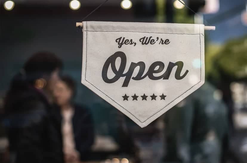Open sign indicating business is operational and welcoming customers.