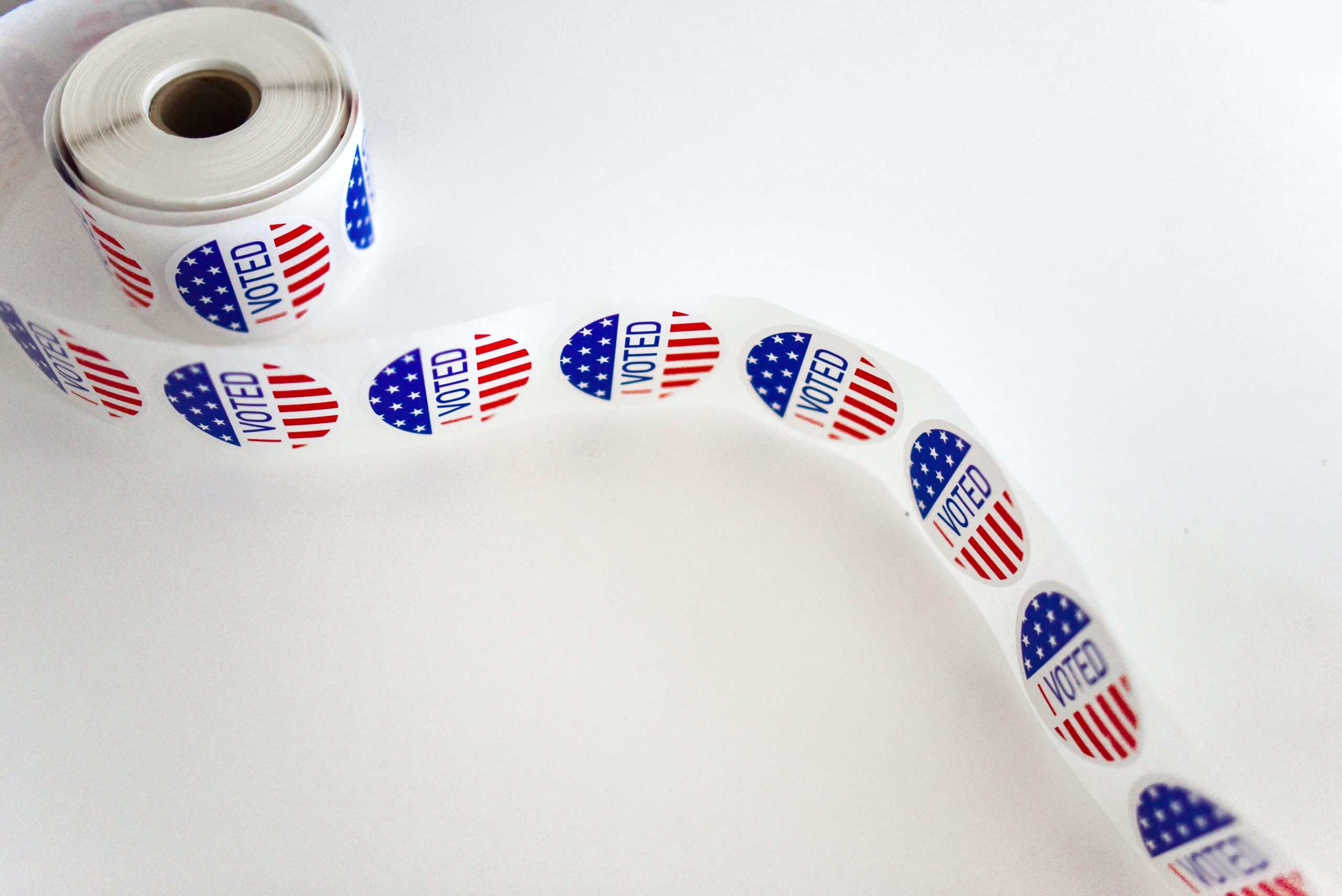 Voter ballot tape with "VOTED" stickers for upcoming judicial primary elections.