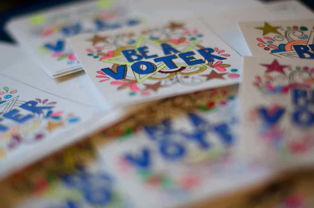 Colorful "Be a Voter" stickers promoting Latino civic engagement.