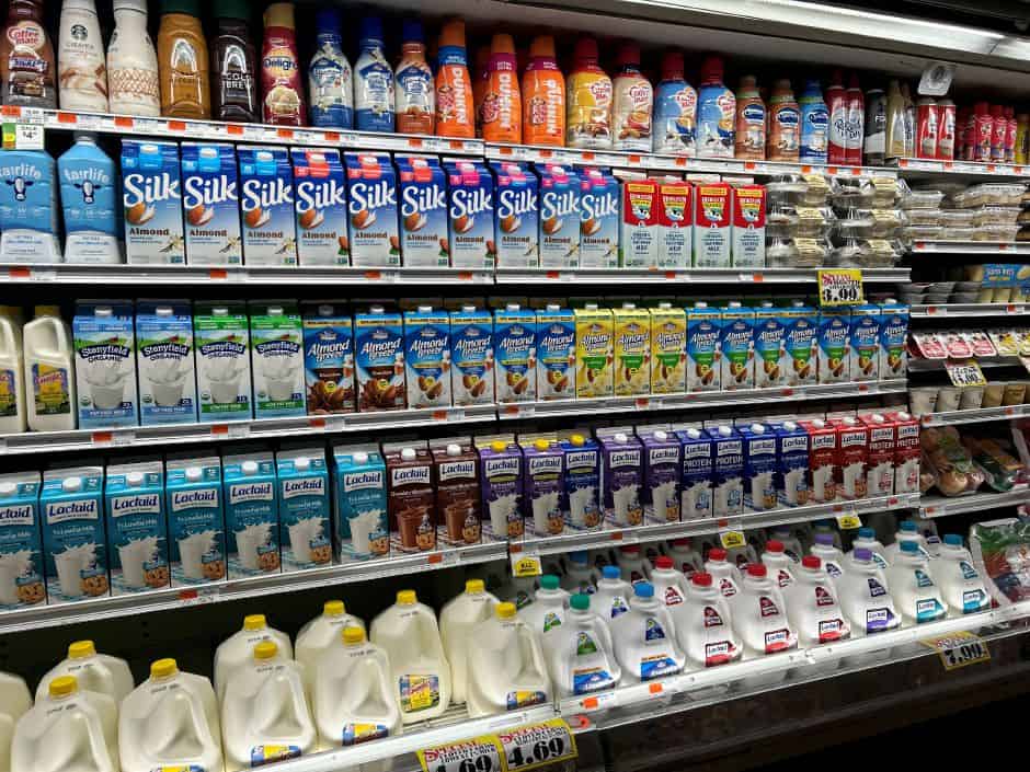 Silk and Lactaid plant-based milk and dairy products on grocery store shelves.