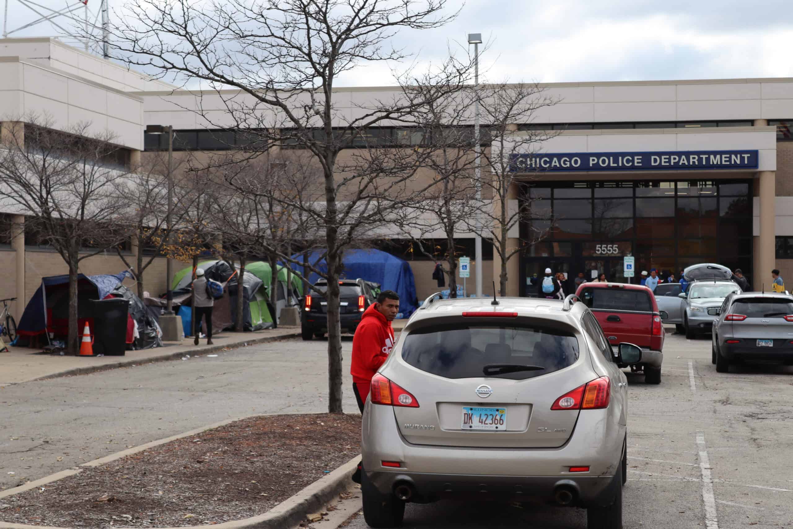 Migrants seeking assistance outside Chicago Police Department building.