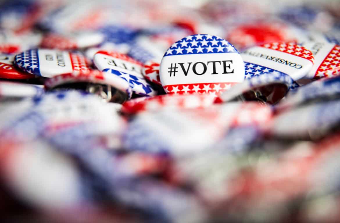 Voter buttons with #VOTE hashtag for Nevada 2024 election, emphasizing civic participation.