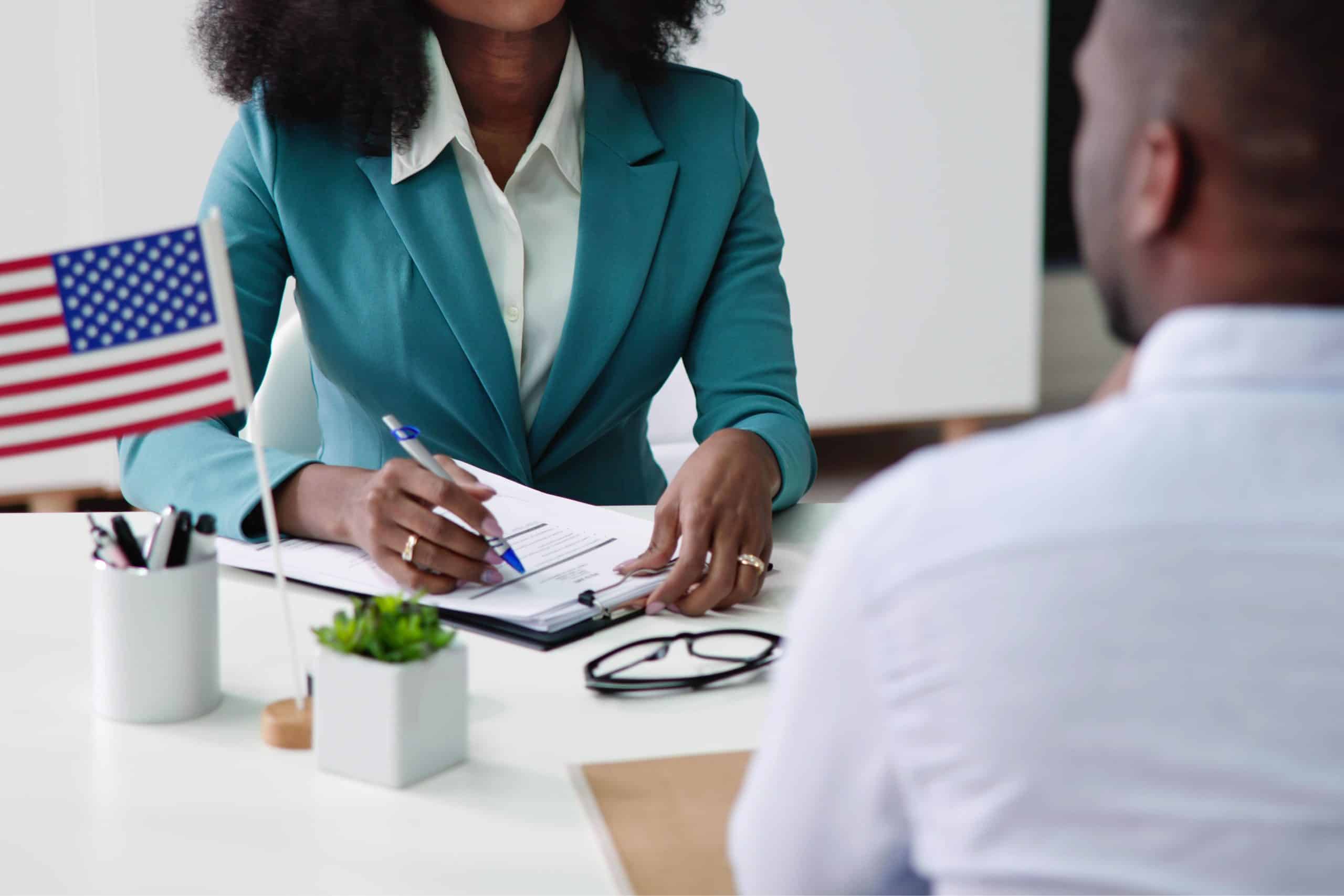 US immigration interview with official discussing work permits and immigration policies.