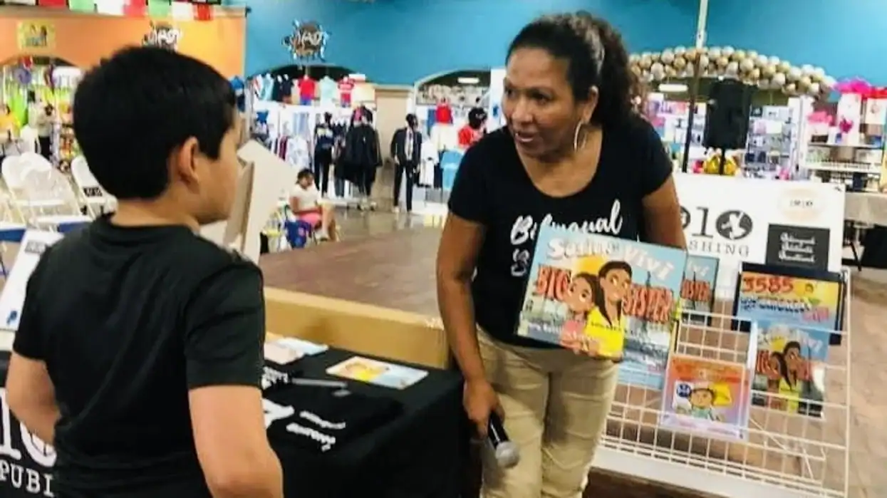 Latino voter talking to a young man at a community event in Georgia.