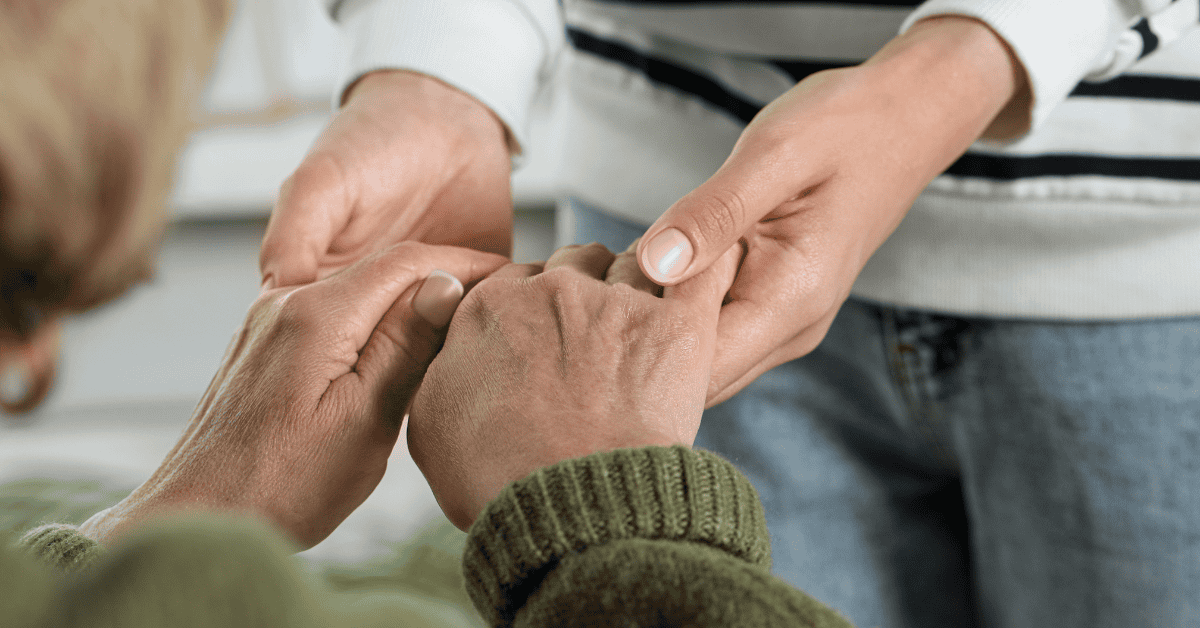 Caregiver offering support and comfort to an elderly person in need.