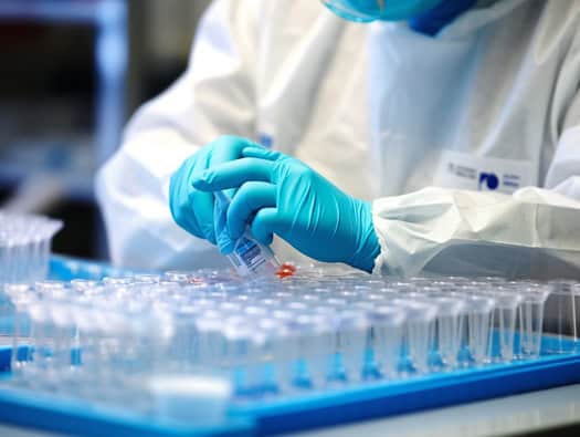Latino scientists working on genetic research for medical advancements.