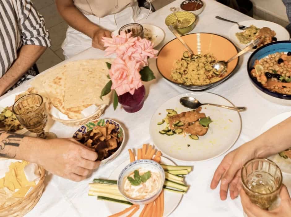 Eating traditional Mexican dishes at a family dinner table, highlighting cultural food and social ga.