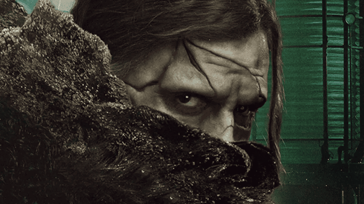 Guillermo del Toro’s Frankenstein creature with intense gaze and gothic background.