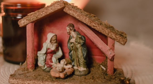 Nativity scene depicting Latino family celebrating Nochebuena Christmas tradition.