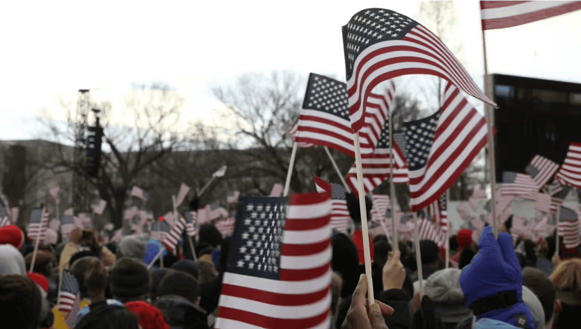 American flags at a rally representing Latino community perspectives on democracy and political enga.