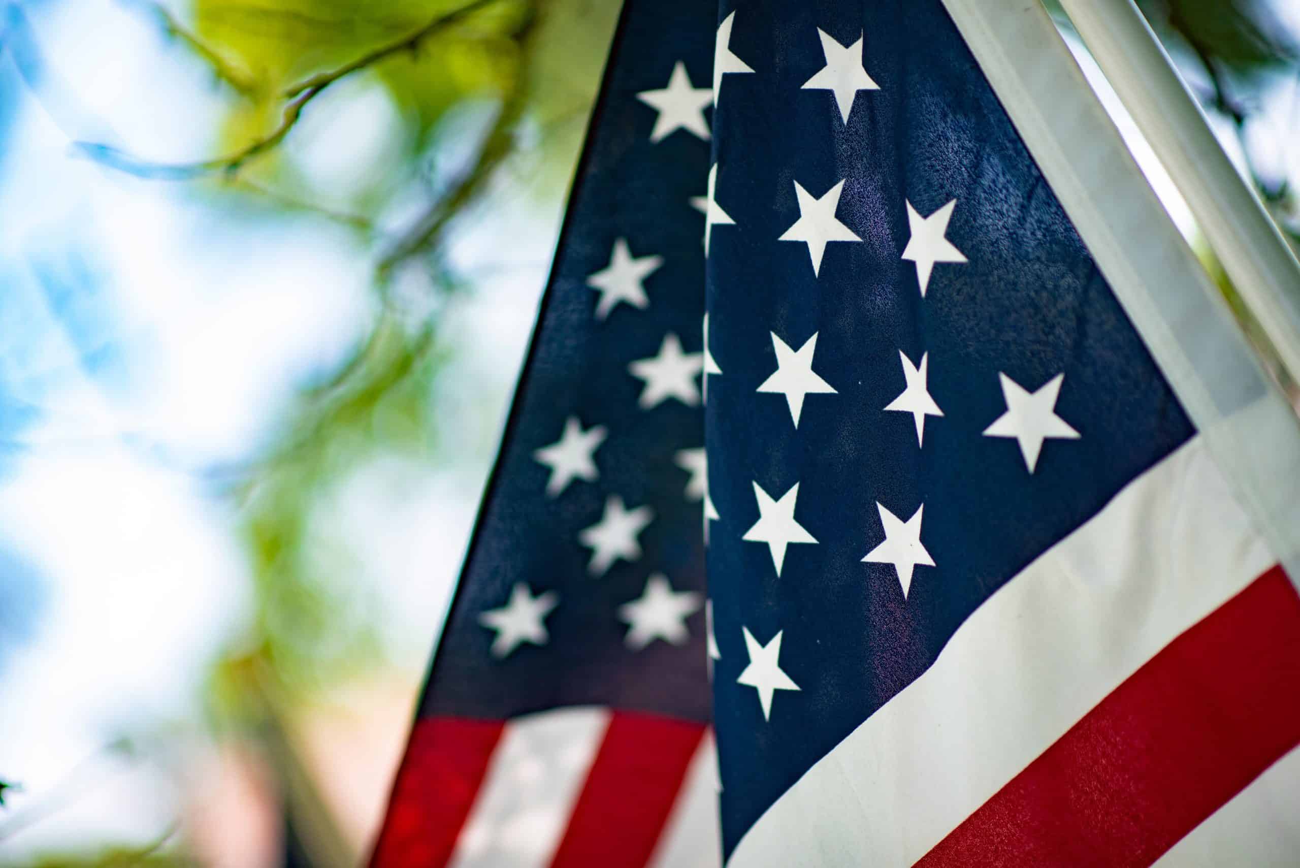Close-up of American flag with stars and stripes at outdoor event.
